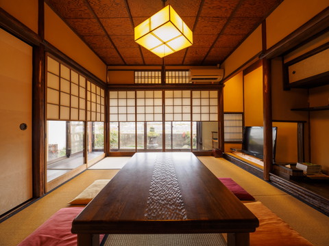 Japanese style room with a table and TV
